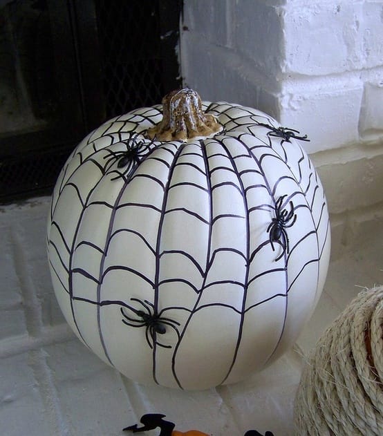 Web-drawn-with-a-sharpie-and-glued-plastic-spiders-on-the-pumpkin_ 5 Incredible Pumpkin Painting Ideas for Halloween